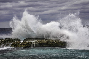 A large wave pounds Northwest Point in Grand Cayman. by Glenn Ostle 
